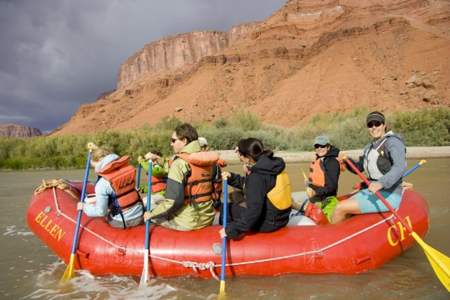 Five people paddling a river raft in Utah